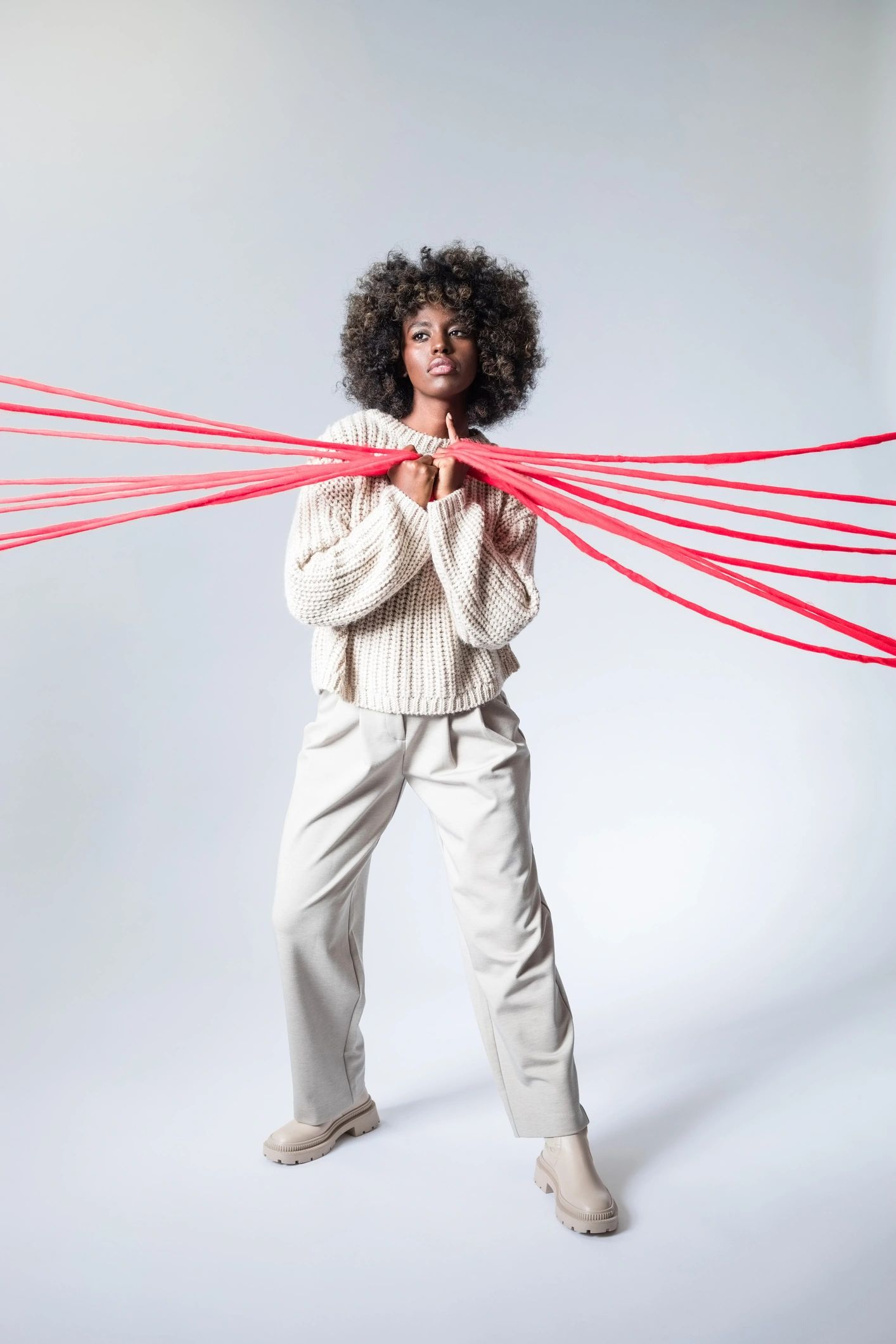 Fashion portrait of a woman in a white sweater