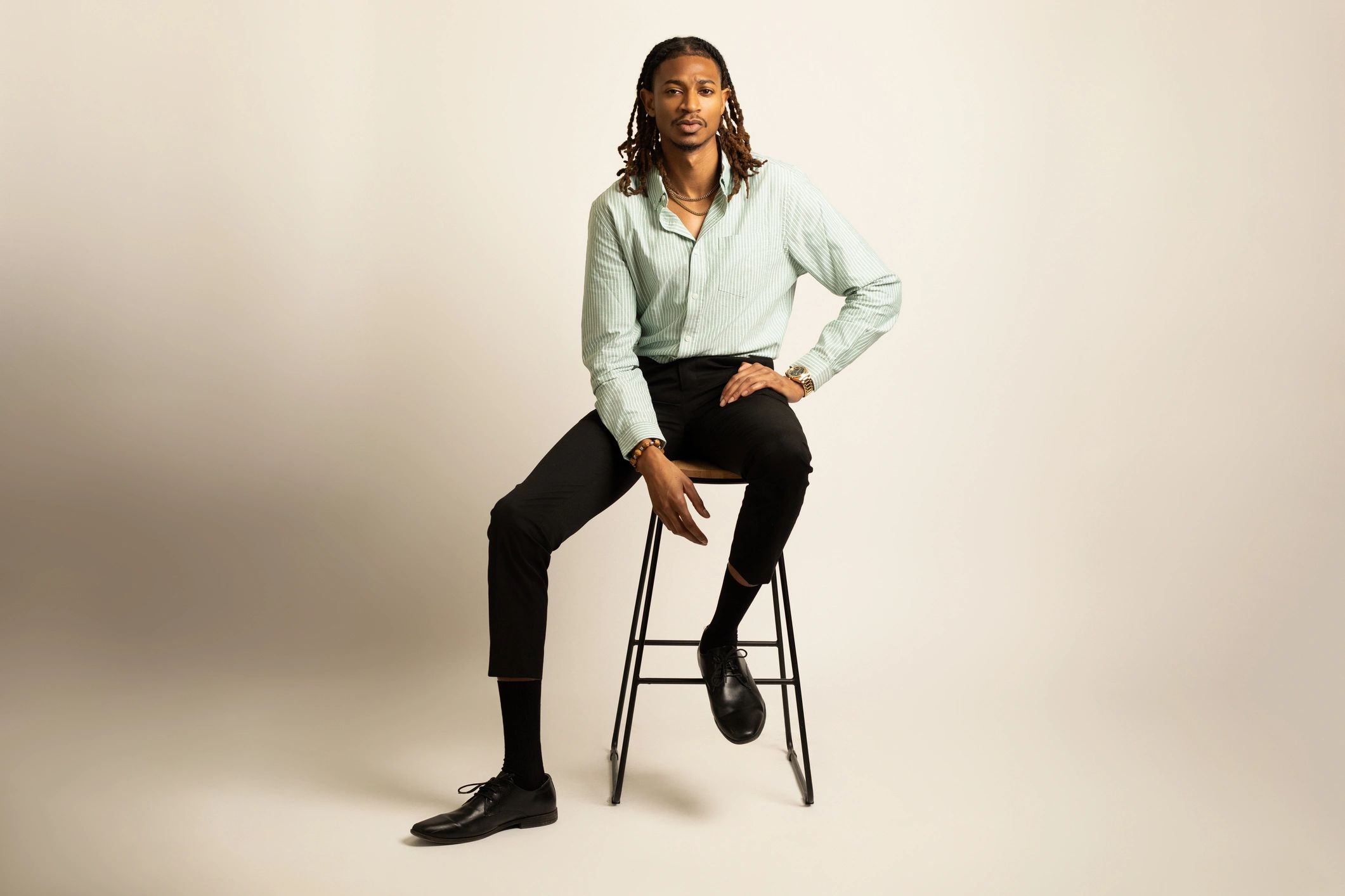 Fashionable man seated in a studio portrait